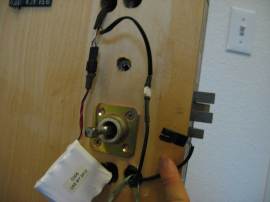 Disassembling the door lock to tie the string.